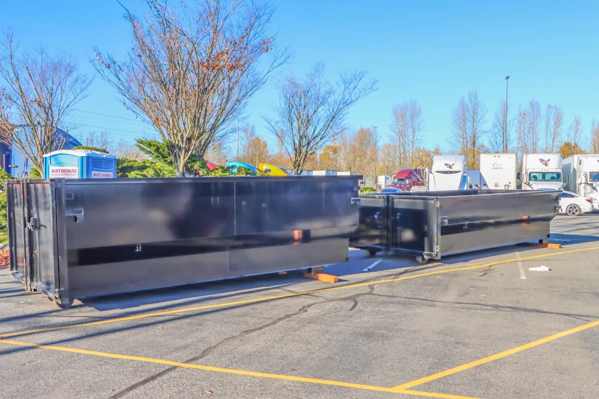 Professional dumpster rental service with roll-off container on residential driveway in Kirkland